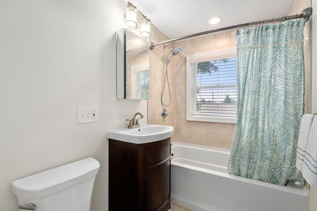 28 Rose Avenue, Unit 28 Watertown, MA 02472 - Photo 14 of 25 a bathroom with a sink a toilet and shower