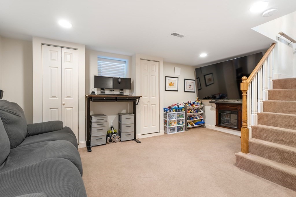 28 Rose Avenue, Unit 28 Watertown, MA 02472 - Photo 18 of 25 a living room with furniture and a flat screen tv
