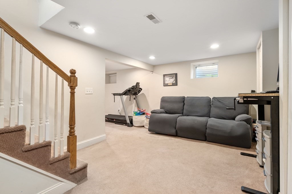 28 Rose Avenue, Unit 28 Watertown, MA 02472 - Photo 19 of 25 a living room with furniture a large window and potted plants