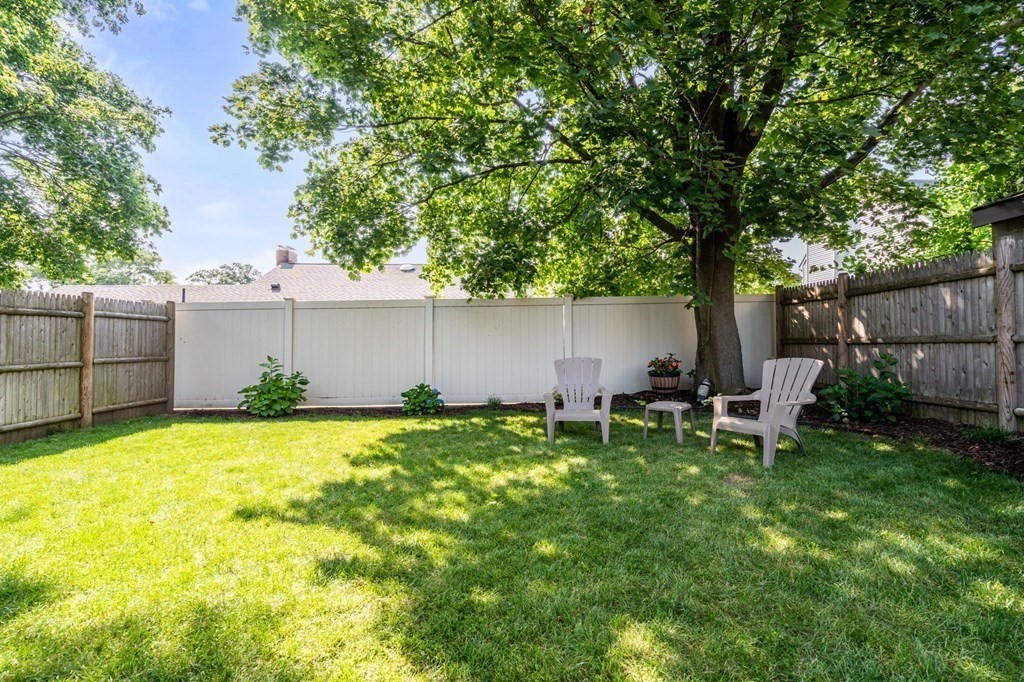 28 Rose Avenue, Unit 28 Watertown, MA 02472 - Photo 25 of 25 a backyard of a house with table and chairs