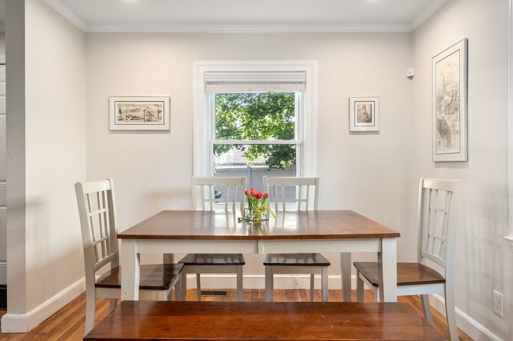 28 Rose Avenue, Unit 28 Watertown, MA 02472 - Photo 9 of 25 a view of a dining room with furniture wooden floor and a window