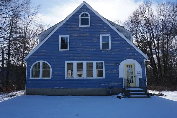 a view of a brick house with a yard