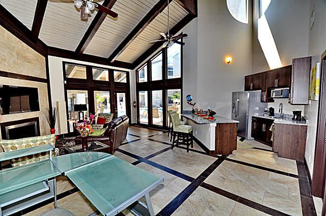 6910 Skillman Street, Unit 1007 Dallas, TX 75231 - Photo 16 of 24 a living room with furniture a flat screen tv and a floor to ceiling window