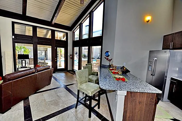 a view of a patio with table and chairs and potted plants