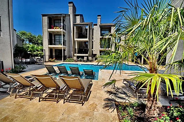 a view of a backyard with plants and outdoor seating