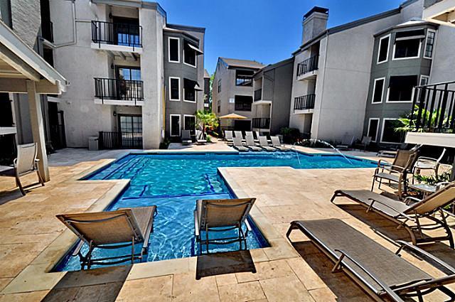 6910 Skillman Street, Unit 1007 Dallas, TX 75231 - Photo 22 of 24 a view of a patio with table and chairs couches with wooden floor