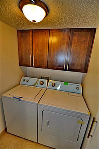6910 Skillman Street, Unit 1007 Dallas, TX 75231 - Photo 7 of 24 a utility room with dryer and washer