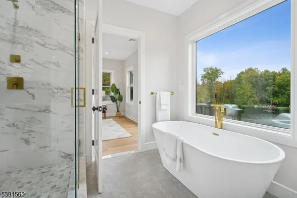 a bathroom with a shower a mirror and a sink