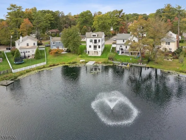 a view of a lake with a houses in the back