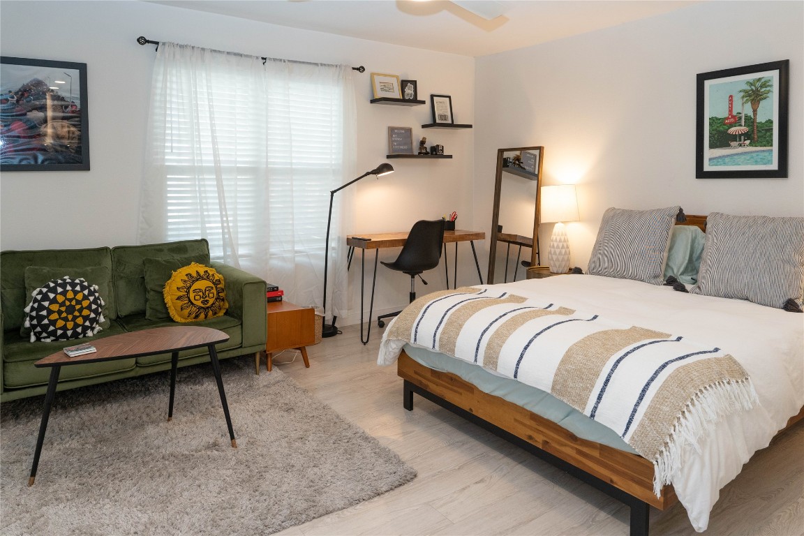 a bedroom with bed and wooden floor