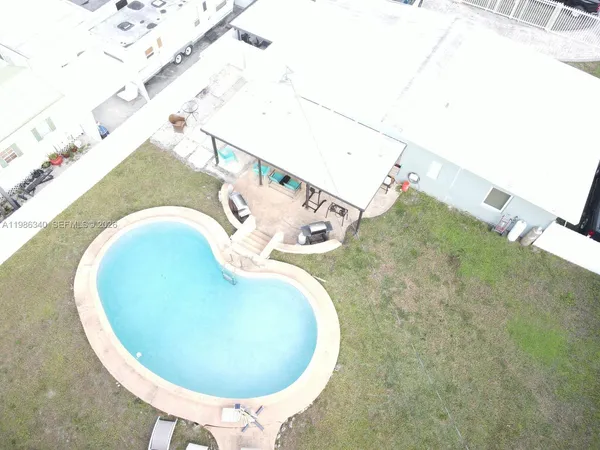 an aerial view of a house with a yard and a garden