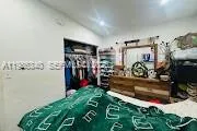 a kitchen with refrigerator and cabinets