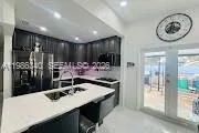 a kitchen with a table and chairs in it