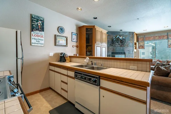 a kitchen with stainless steel appliances granite countertop a stove microwave and refrigerator