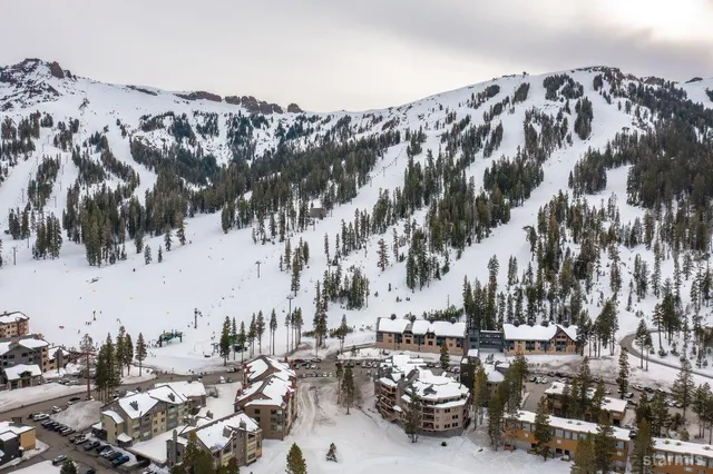 an aerial view of a backyard with table and chairs