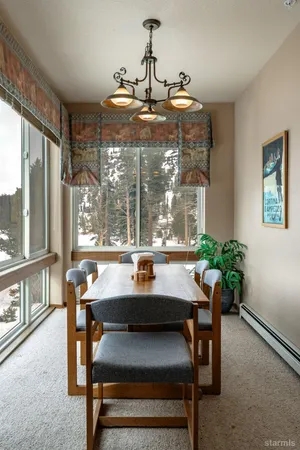 a kitchen with stainless steel appliances a stove top oven a sink a refrigerator white cabinets and wooden floor
