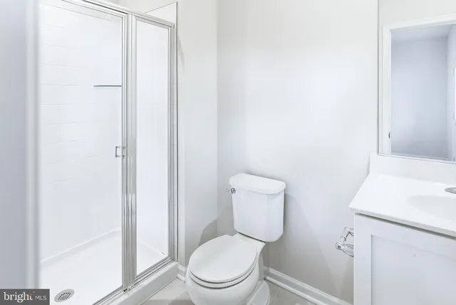 a white toilet sitting next to a bathroom sink