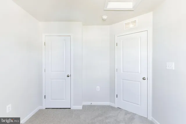 an empty room with closet area