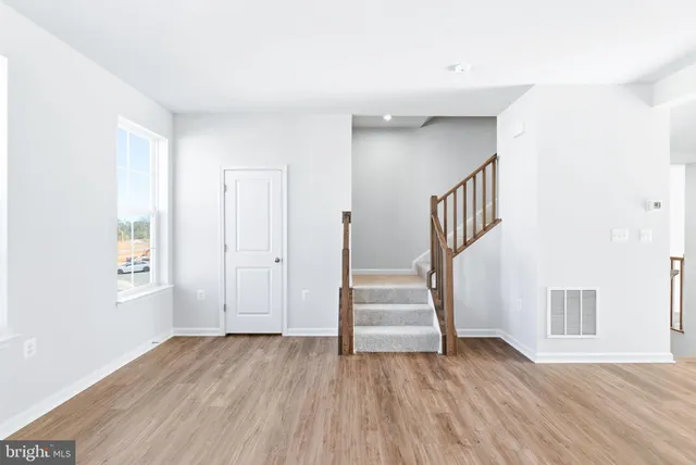a view of staircase with white walls and a window