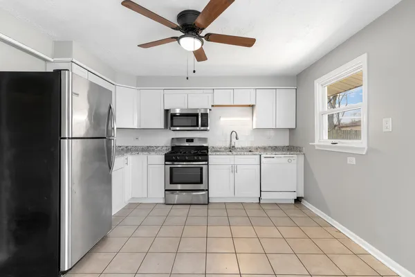 a kitchen with granite countertop cabinets and steel stainless steel appliances with cabinets