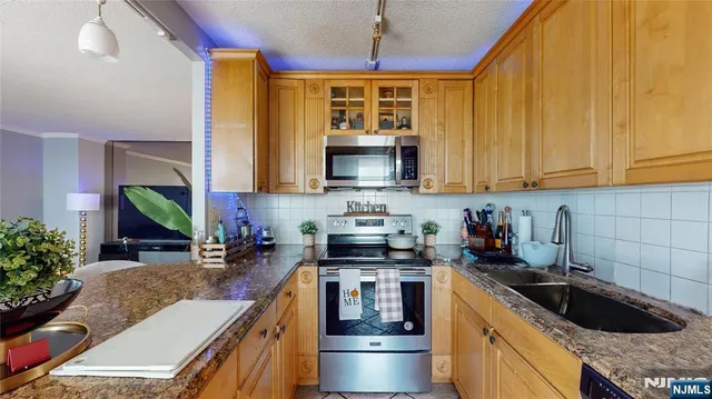 a kitchen with a stove a sink and a microwave