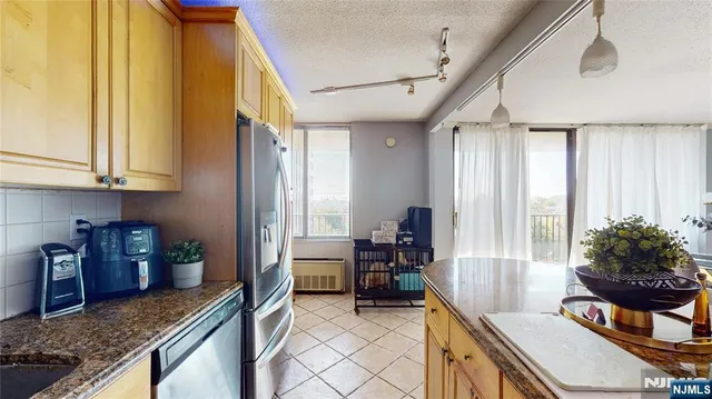a kitchen with sink refrigerator and window