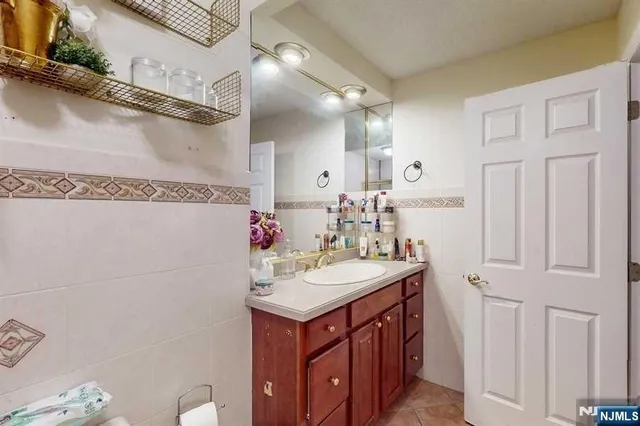 a bathroom with a sink vanity granite and a mirror