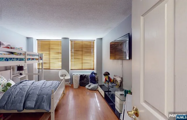 a living room with furniture a flat screen tv and a window