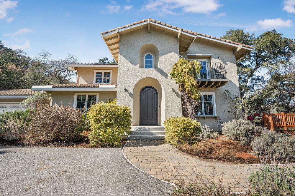 a front view of a house with garden