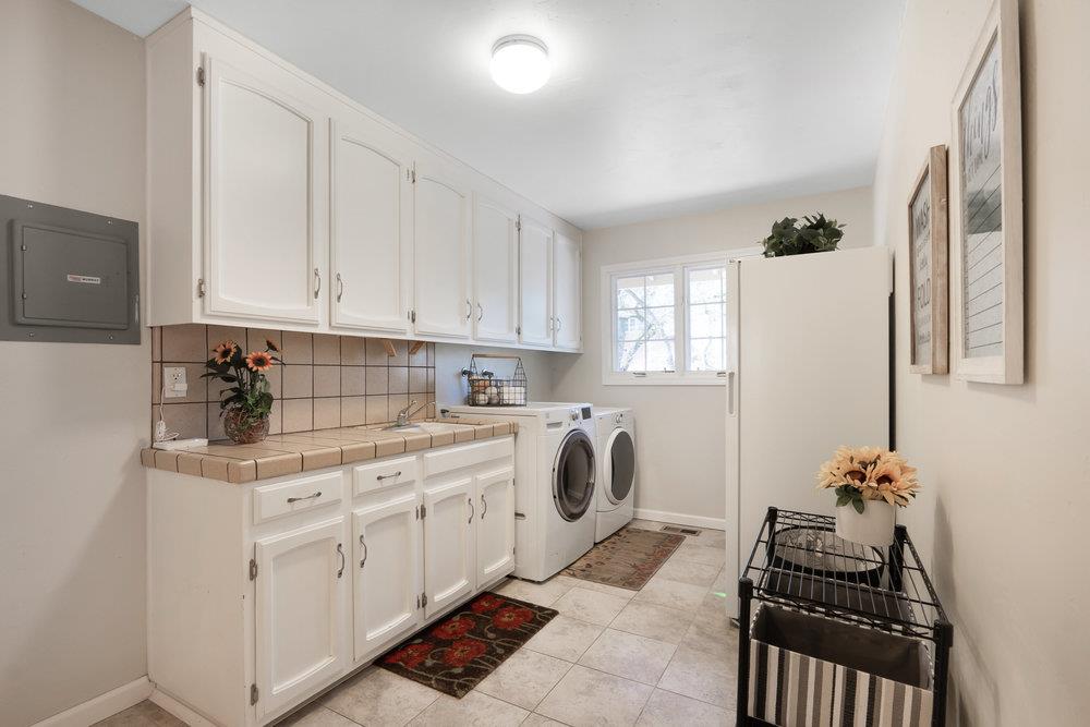 9160 Paseo Tranquillo Gilroy, CA 95020 - Photo 23 of 44 a kitchen with a white cabinets and window
