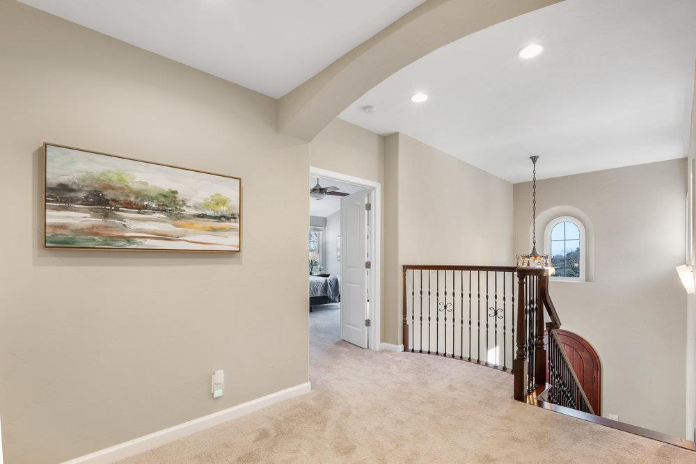 9160 Paseo Tranquillo Gilroy, CA 95020 - Photo 25 of 44 a view of a hallway with paintings on the wall