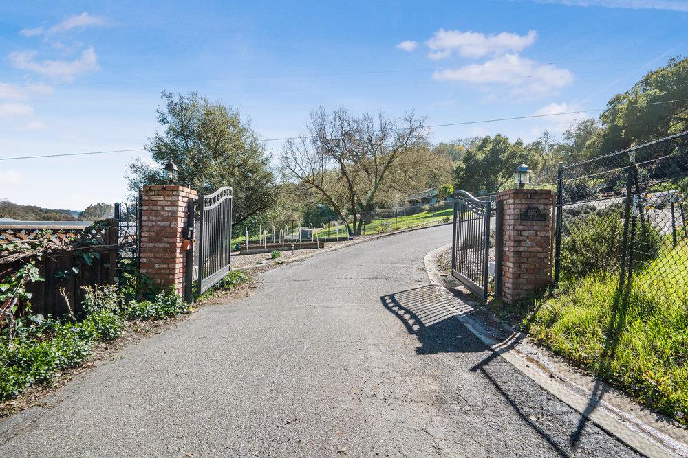 9160 Paseo Tranquillo Gilroy, CA 95020 - Photo 3 of 44 a view of a street with benches and a small yard