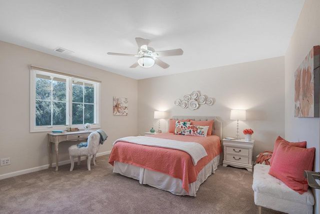 a bedroom with a bed and a table in it