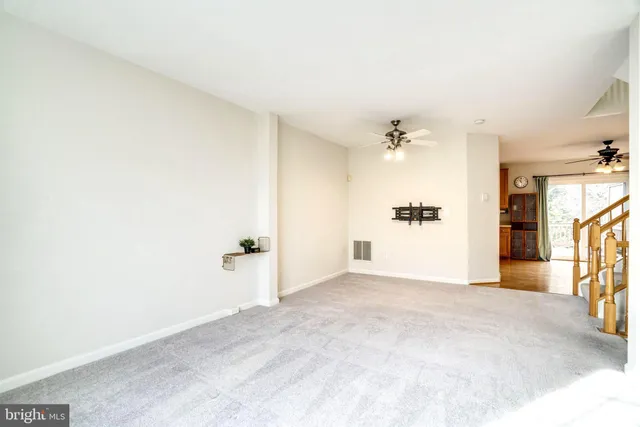 a view of a kitchen with a sink and a refrigerator