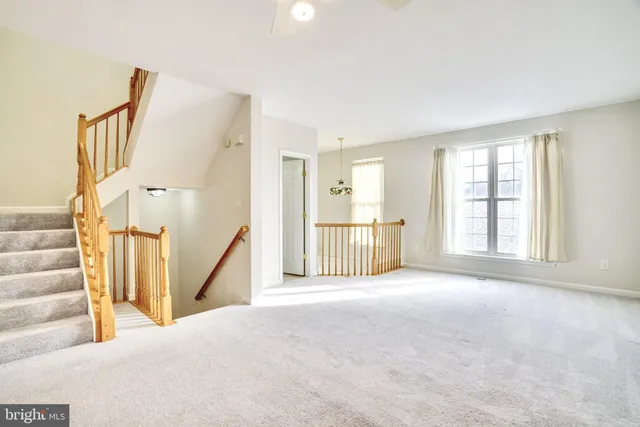 a view of an empty room with a fireplace and a large window