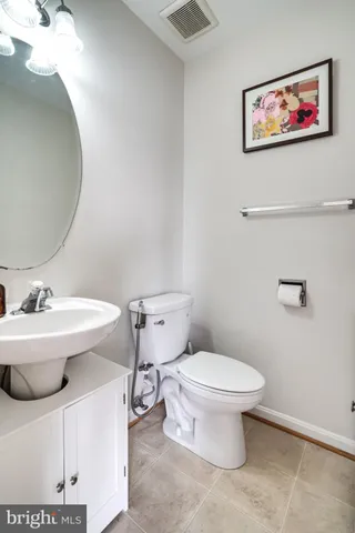 a white toilet sitting next to a bathroom sink