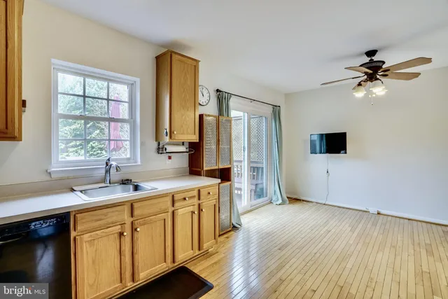 a kitchen with a sink appliances and a window