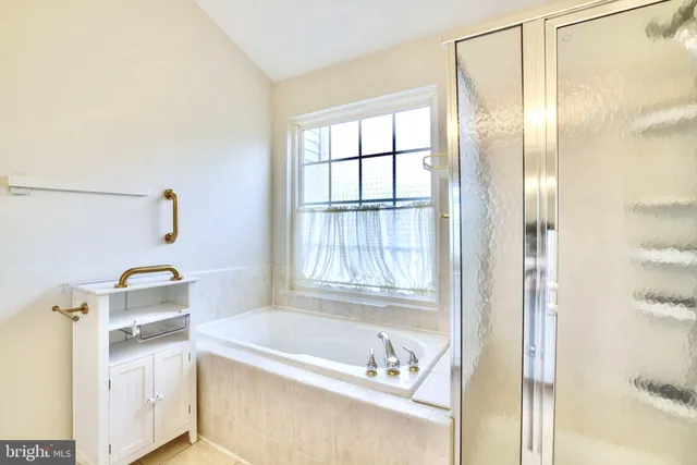a bathroom with a tub and a window