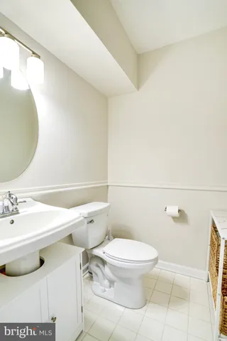 a bathroom with a sink mirror vanity and toilet