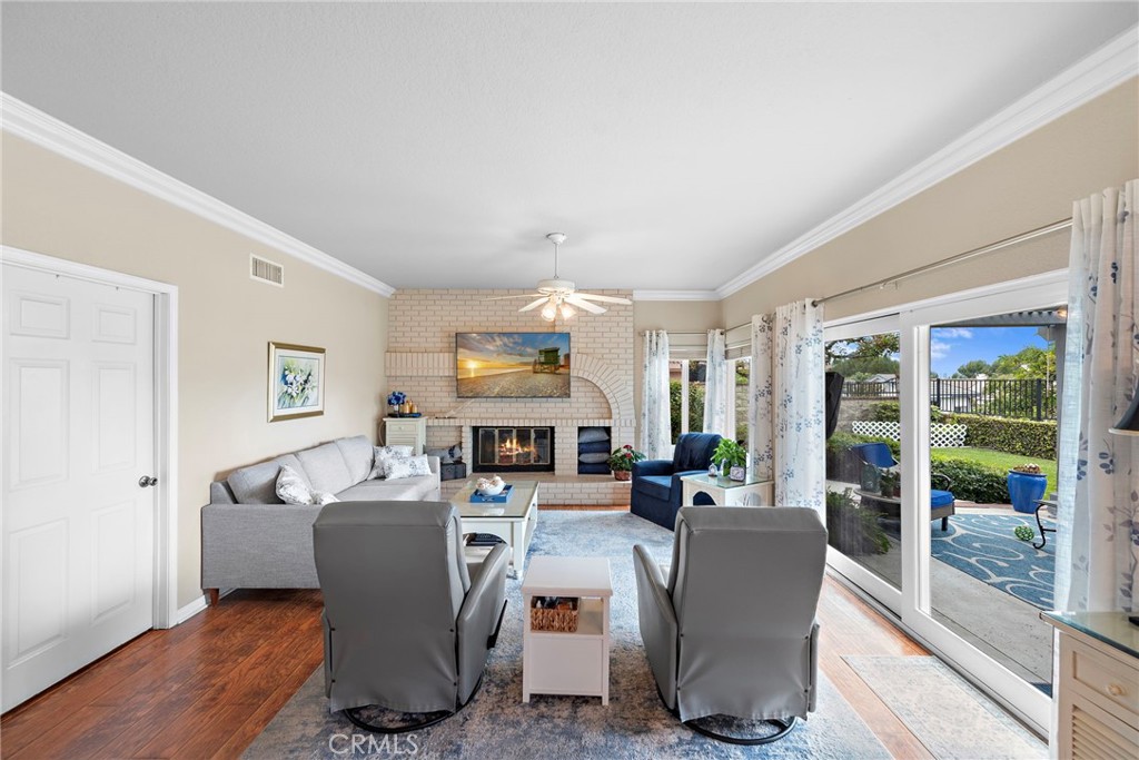 28811 Walnut Grove Mission Viejo, CA 92692 - Photo 15 of 48 a living room with couches a coffee table and a large window with garden view