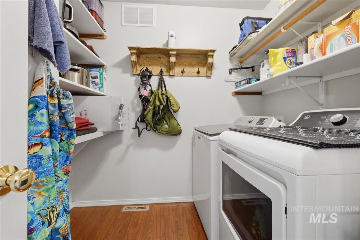 5002 Northrup Way Caldwell, ID 83607 - Photo 11 of 38 Laundry room with light wood-style flooring and separate washer and dryer