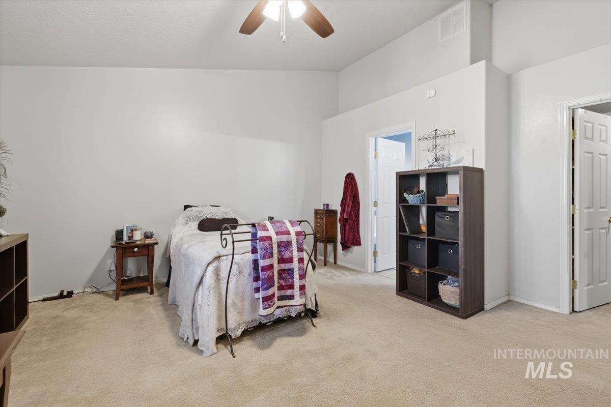 5002 Northrup Way Caldwell, ID 83607 - Photo 20 of 38 Bedroom featuring light colored carpet, a ceiling fan, and vaulted ceiling