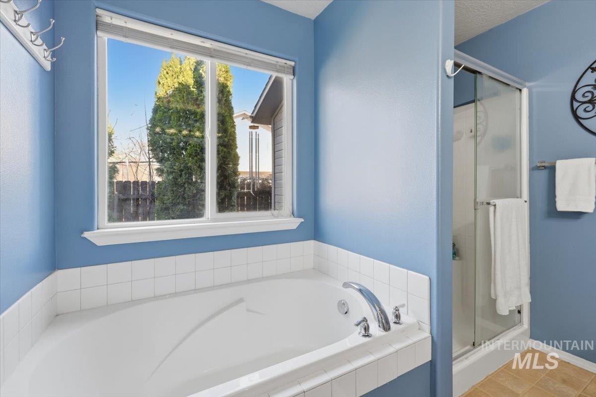 5002 Northrup Way Caldwell, ID 83607 - Photo 24 of 38 Bathroom featuring a garden tub and a stall shower