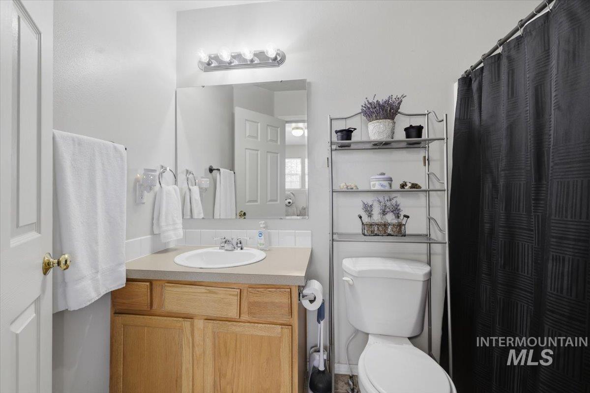 5002 Northrup Way Caldwell, ID 83607 - Photo 28 of 38 Bathroom featuring vanity and a shower with curtain