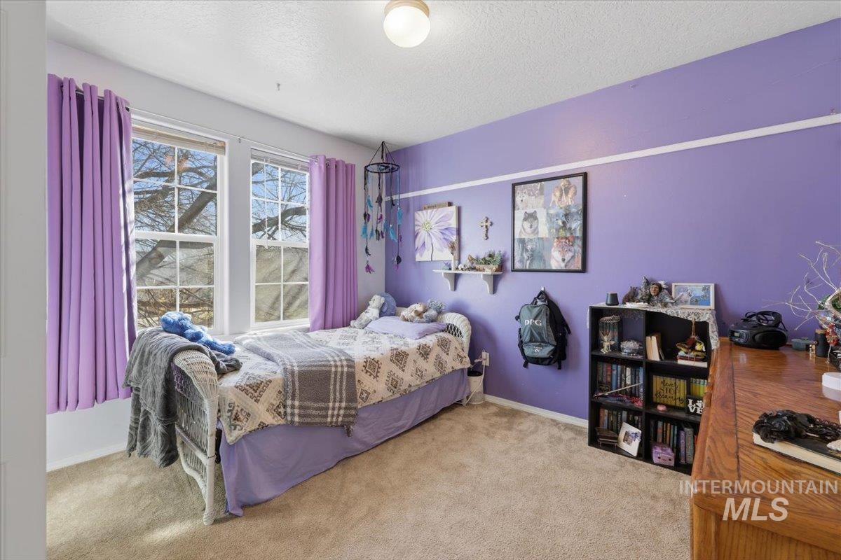 5002 Northrup Way Caldwell, ID 83607 - Photo 29 of 38 Carpeted bedroom with a textured ceiling and baseboards