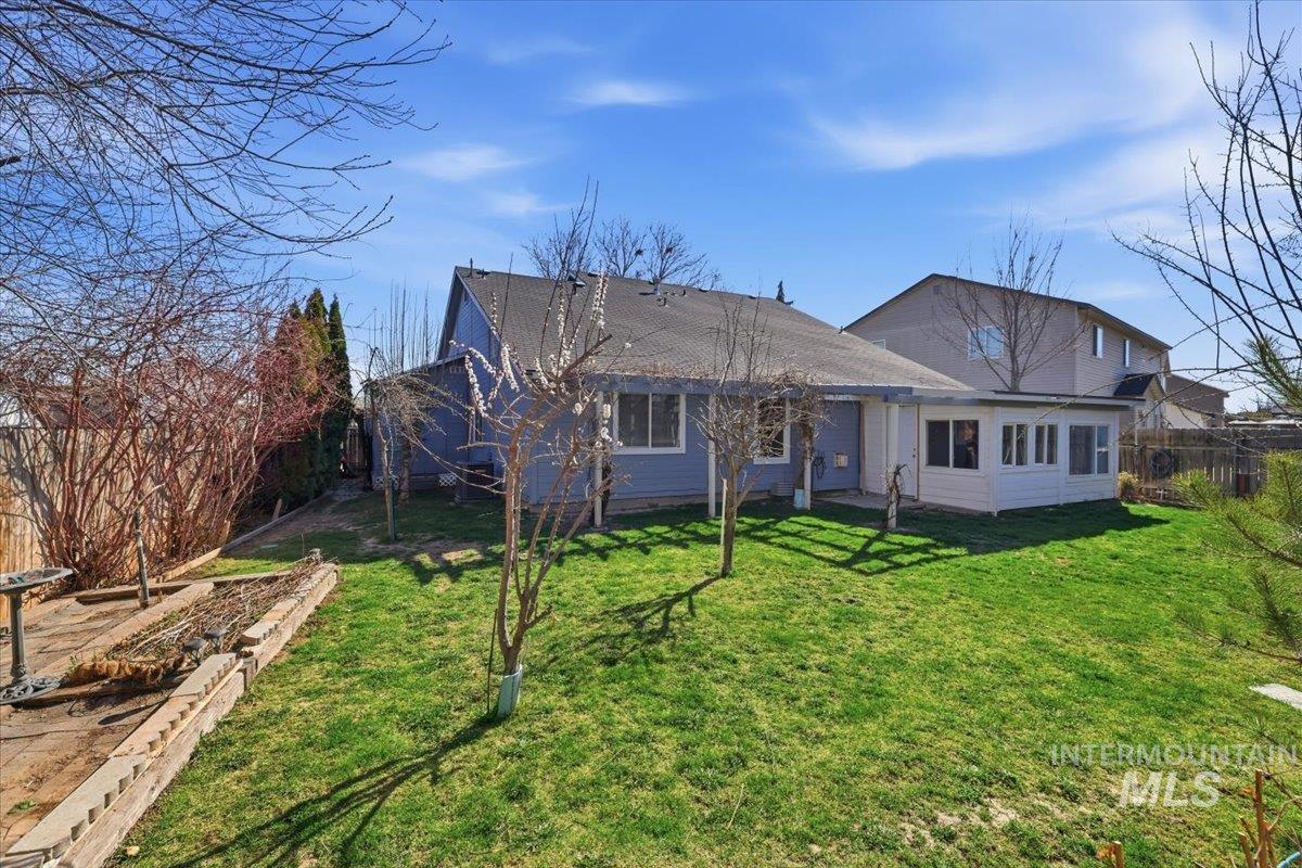 5002 Northrup Way Caldwell, ID 83607 - Photo 35 of 38 Back of house with a fenced backyard and roof with shingles