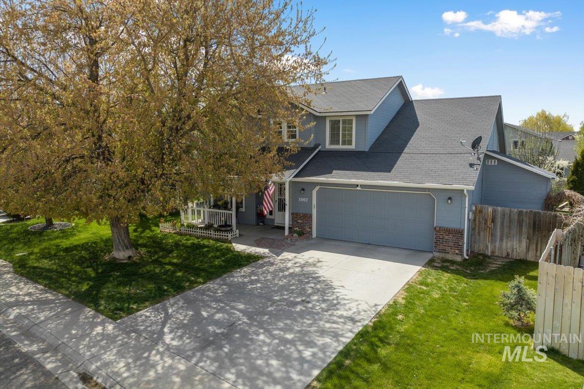 5002 Northrup Way Caldwell, ID 83607 - Photo 4 of 38 View of front of property featuring brick siding, concrete driveway, roof with shingles, and an attached garage