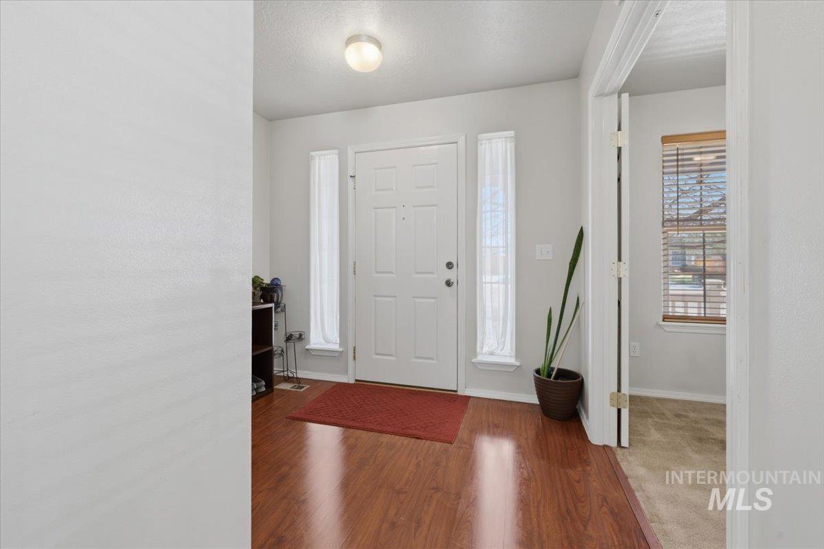 5002 Northrup Way Caldwell, ID 83607 - Photo 6 of 38 Entrance foyer featuring wood finished floors, a textured ceiling, and plenty of natural light