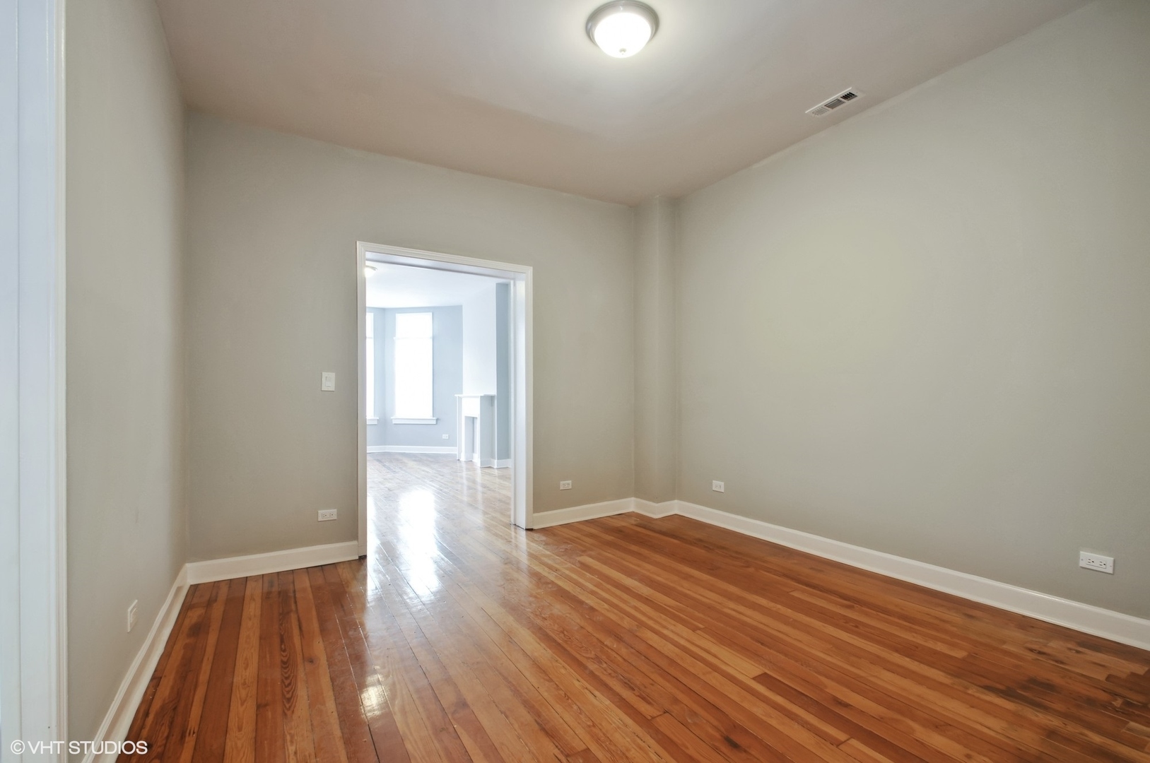 3833 West Arthington Street Chicago, IL 60624 - Photo 8 of 22 a view of an empty room with wooden floor