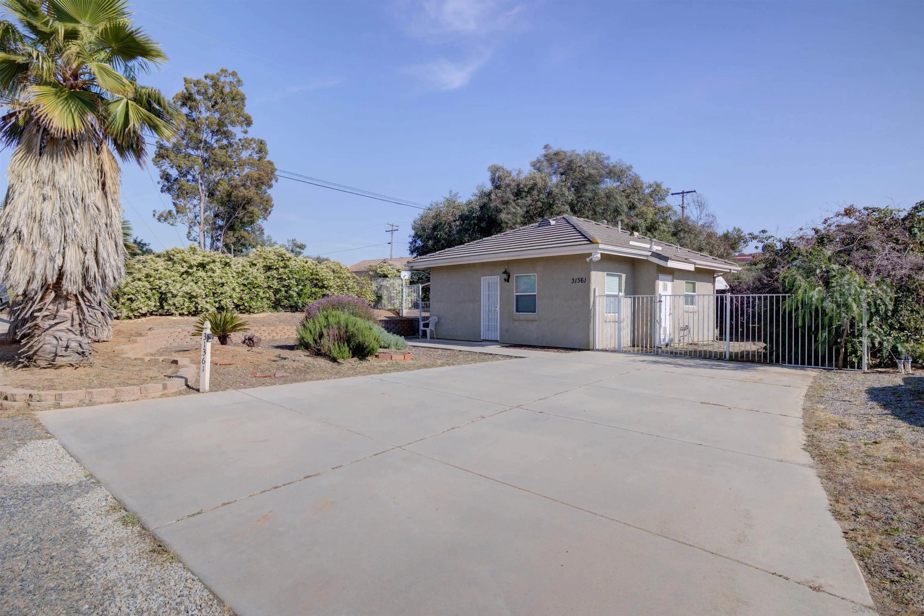 31363 Ahern Ranch Road Valley Center, CA 92082 - Photo 34 of 48 front view of a house with a yard and potted plants